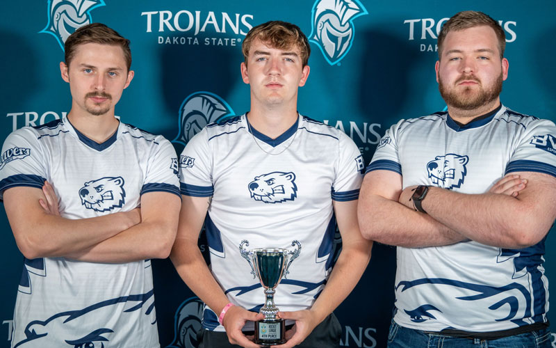 Esports team holding a trophy